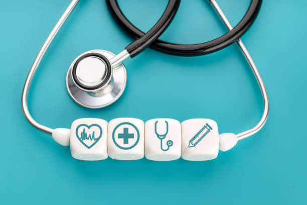 preventative healthcare concept of stethoscope with medical icons on dices