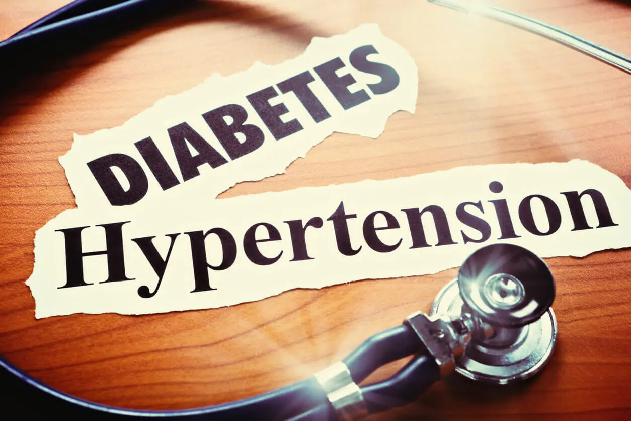 Image of Diabetes and hypertension written on paper as headlines with a stethoscope.